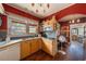 Charming kitchen with wood cabinets, stainless sink, open shelves, and access to the next room at 910 E North Bay St, Tampa, FL 33603