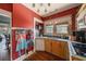 Cozy kitchen featuring wood cabinets, a double basin sink, and aprons hanging on the wall at 910 E North Bay St, Tampa, FL 33603