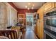 Functional kitchen area featuring wooden cabinetry, stainless steel appliances, and an adjacent dining space at 910 E North Bay St, Tampa, FL 33603