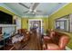 Inviting living room with hardwood floors, warm paint, a fireplace, and access to the dining room at 910 E North Bay St, Tampa, FL 33603