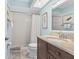 Well-lit bathroom with a walk-in shower, vanity, and coastal decor at 911 Harbour House Dr, Indian Rocks Beach, FL 33785
