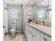 Bathroom featuring white vanity and fixtures, and a large mirror at 911 Harbour House Dr, Indian Rocks Beach, FL 33785