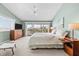 The main bedroom is airy and bright, with sliding doors to a balcony and balcony views at 911 Harbour House Dr, Indian Rocks Beach, FL 33785