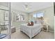 Cozy bedroom with a white bed, wicker furniture, and plenty of natural light at 911 Harbour House Dr, Indian Rocks Beach, FL 33785