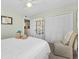 Comfortable bedroom featuring neutral tones, white furniture, and ample closet space at 911 Harbour House Dr, Indian Rocks Beach, FL 33785