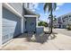 Close-up of a townhouse featuring a garage door, front entryway, and nautical-themed mermaid decor at 911 Harbour House Dr, Indian Rocks Beach, FL 33785