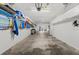 A spacious garage with overhead racks and storage, providing ample room for vehicles and storage at 911 Harbour House Dr, Indian Rocks Beach, FL 33785