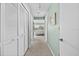 Hallway view with bedroom at the end and closet on the left, all in light neutral colors at 911 Harbour House Dr, Indian Rocks Beach, FL 33785