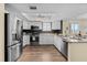 Well-lit kitchen featuring stainless steel appliances, white cabinetry, and modern fixtures at 911 Harbour House Dr, Indian Rocks Beach, FL 33785