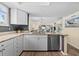 Bright kitchen featuring granite countertops, stainless steel appliances, and wood flooring at 911 Harbour House Dr, Indian Rocks Beach, FL 33785