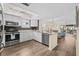 Bright kitchen with white cabinets, stainless steel appliances, and granite countertops at 911 Harbour House Dr, Indian Rocks Beach, FL 33785