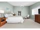 The main bedroom is spacious and bright, featuring a TV, ensuite access, and a neutral color palette at 911 Harbour House Dr, Indian Rocks Beach, FL 33785