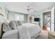 The main bedroom has a ceiling fan, large windows, fresh paint, and a king bed with cozy, comfortable bedding at 911 Harbour House Dr, Indian Rocks Beach, FL 33785