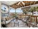 Inviting patio with stylish seating, tropical plants, and a view of the community at 911 Harbour House Dr, Indian Rocks Beach, FL 33785