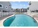A large community pool with lounge chairs, offering a refreshing and social space for residents at 911 Harbour House Dr, Indian Rocks Beach, FL 33785