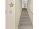 A carpeted staircase with white walls, leading up to the next floor of the home at 911 Harbour House Dr, Indian Rocks Beach, FL 33785