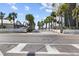 A charming street view leading to the beach, lined with palm trees and picturesque homes at 911 Harbour House Dr, Indian Rocks Beach, FL 33785