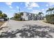 A neighborhood street featuring modern townhouses with well-kept exteriors and greenery at 911 Harbour House Dr, Indian Rocks Beach, FL 33785