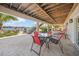 This home's beautiful back patio has comfortable seating and a staircase leading to the home's waterfront pier at 931 Inlet Cir, Venice, FL 34285
