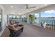 Spacious covered balcony features comfortable lounge furniture with beautiful views of the intercoastal waterway at 931 Inlet Cir, Venice, FL 34285