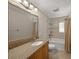 Clean, traditional bathroom with single vanity and shower-tub combination at 931 Inlet Cir, Venice, FL 34285