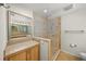 Clean, neutral bathroom featuring a glass shower, a large mirror, and a single-sink vanity at 931 Inlet Cir, Venice, FL 34285