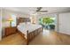 The main bedroom boasts a large, carved wood bed frame and access to the outdoor terrace at 931 Inlet Cir, Venice, FL 34285