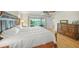 Bright, spacious bedroom offers terrace access, a ceiling fan, and a classic carved wood bed frame at 931 Inlet Cir, Venice, FL 34285