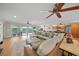 Open-concept living space with hardwood floors, comfortable seating and direct access to outdoor patio at 931 Inlet Cir, Venice, FL 34285