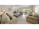 The living room includes comfortable seating and access to the outdoor patio overlooking the water at 931 Inlet Cir, Venice, FL 34285