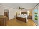 Spacious main bedroom with ensuite bathroom, a large bed frame, and a doorway to the outdoor terrace at 931 Inlet Cir, Venice, FL 34285