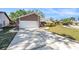 Attractive home with a large driveway, two-car garage, and beautiful front lawn at 9718 Lomalinda Ct, New Port Richey, FL 34655
