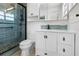 Updated bathroom features a modern walk-in shower and bright white vanity with storage at 109 Carmelina St, Ruskin, FL 33570