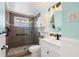 Updated bathroom featuring a tiled walk-in shower and modern vanity with ample storage at 109 Carmelina St, Ruskin, FL 33570