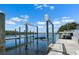 Boat lift on a home dock with a scenic view of the calm river and sunny sky at 109 Carmelina St, Ruskin, FL 33570