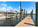 Wide wooden home dock on the water with boat lift capabilities for waterfront living at 109 Carmelina St, Ruskin, FL 33570