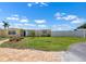 Yellow home with a blue front door and well-manicured lawn and landscape at 109 Carmelina St, Ruskin, FL 33570