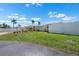 Charming yellow waterfront home with a white fence and green lawn at 109 Carmelina St, Ruskin, FL 33570