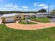Charming yellow waterfront home featuring a brick circular driveway and well-manicured lawn at 109 Carmelina St, Ruskin, FL 33570