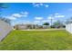Charming yellow home with attached garage, a white fence, and a well-maintained lawn at 109 Carmelina St, Ruskin, FL 33570