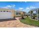 Yellow home with an attached garage and a beautiful circular brick driveway at 109 Carmelina St, Ruskin, FL 33570