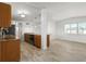 Spacious kitchen with bright lighting, stainless appliances, wood cabinets, and granite counters at 109 Carmelina St, Ruskin, FL 33570