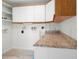 Functional laundry room with counter space and overhead cabinets at 109 Carmelina St, Ruskin, FL 33570
