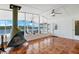 Sunroom with tile floors, waterfront view, fireplace and large windows to enjoy the view at 109 Carmelina St, Ruskin, FL 33570