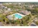 Aerial view of community pool, clubhouse, playground, and lush landscaping at 11109 Great Neck Rd, Riverview, FL 33578