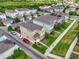 Aerial view showcasing colorful homes with lush green lawns, paved driveways, and parked cars at 11109 Great Neck Rd, Riverview, FL 33578