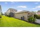 Backyard with a screen enclosed patio and a well-maintained lawn and attached garage at 11109 Great Neck Rd, Riverview, FL 33578
