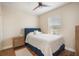 Cozy bedroom features a large window, wood floors, and natural lighting at 11109 Great Neck Rd, Riverview, FL 33578