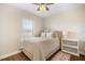 Inviting bedroom features a large window, wood floors, and natural lighting at 11109 Great Neck Rd, Riverview, FL 33578