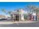 Inviting exterior with decorative columns and colorful storefronts, framed by mature trees and ample parking at 11109 Great Neck Rd, Riverview, FL 33578